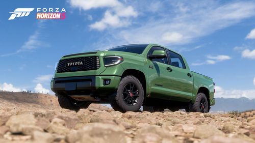 A green Toyota Tundra TRD Pro is parked on top of cream colored rocks.