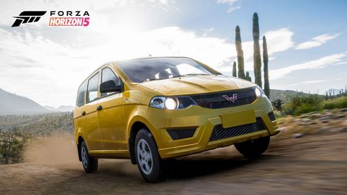 A yellow Wuling Hongguang S drives towards the camera on a dirt trail by cacti and living desert foliage.