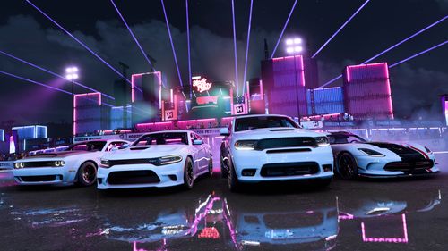 A group of all white Dodge cars are parked in front of a laser show at a festival site at night.